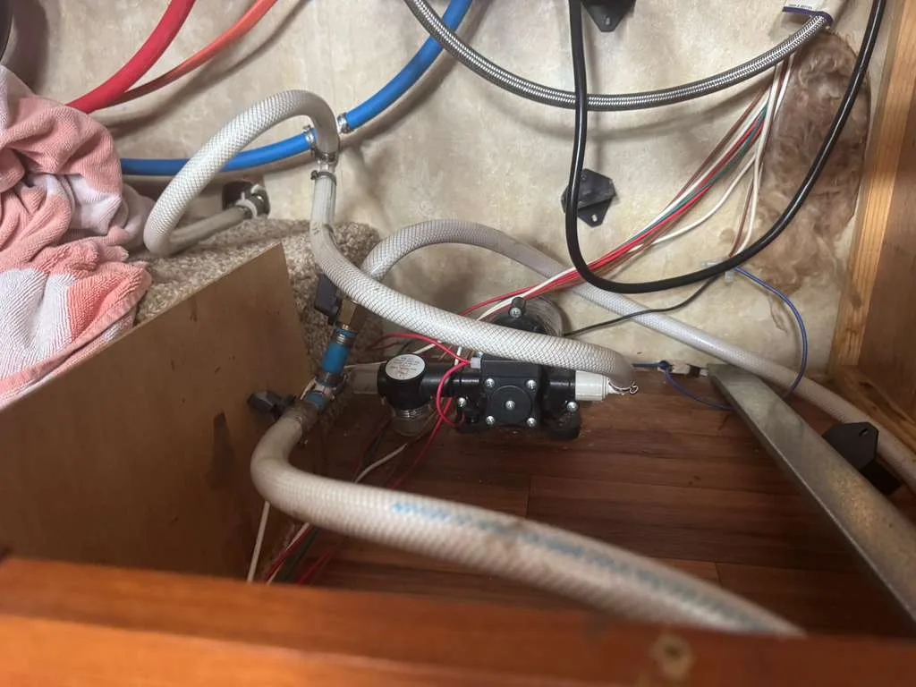 PEX pipe repair and replacement under an RV during a mobile plumbing call