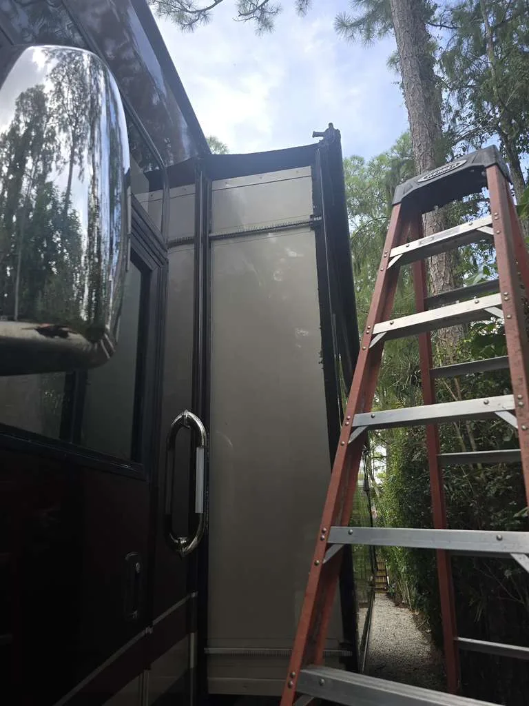 Coast to Coast RV technician working on a stuck slide-out at a Florida campsite